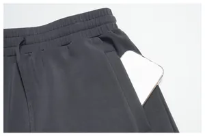Close-up of men's breathable modal sports shorts featuring a deep side pocket for a smartphone
