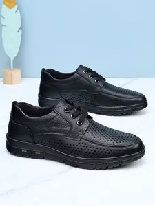 Close-up detail of black perforated leather business casual shoes for men in summer