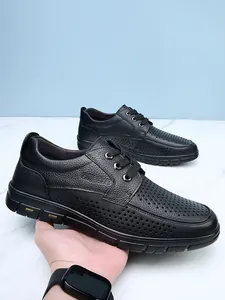Close-up detail of breathable perforated black leather business casual shoes for men