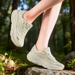Beige carbon plate racing running shoes for men and women shown on a forest trail
