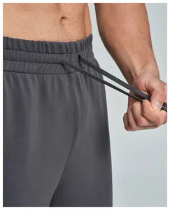 Detail view of elastic waistband and drawstring on dark gray modal sports pants