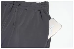 Detailed view of grey modal sports pants with a deep side pocket for a smartphone.