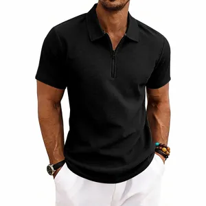 Detail shot showcasing the premium black waffle knit texture on a men's polo shirt