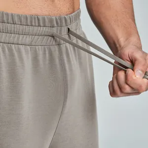 Close-up of men's modal sports trousers with elastic waistband and drawstring detail