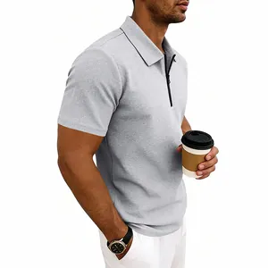 Detailed view of men's grey waffle-knit polo shirt with quarter-zip lapel collar