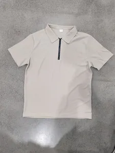 Detailed view of a beige waffle knit men's polo shirt featuring a half-zip collar design
