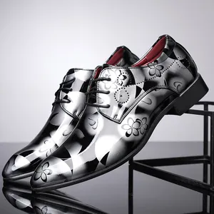 Detailed macro view of men's British style mirror leather shoes with black floral pattern.