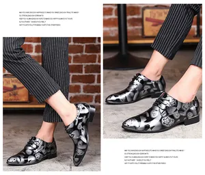 Detail view of men's mirror finish dress shoes with floral pattern and lace-up design