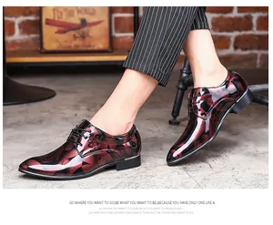 Detailed view of burgundy floral mirror finish men's dress shoes with lace-up design