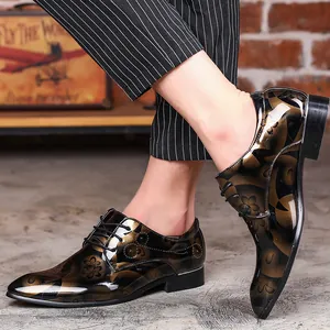 Detail of men's formal oxford shoes featuring a gold floral pattern and mirror finish