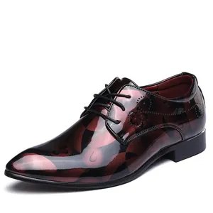 Side view of luxury burgundy patent leather men's dress shoe with floral pattern