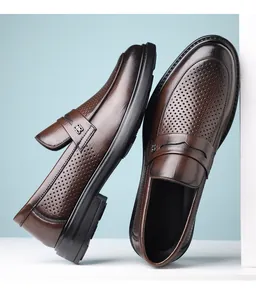 Detail view of brown perforated leather loafers showing business casual slip-on design