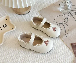 Cream girls' Mary Jane flats with mushroom embroidery and delicate lace trim detail