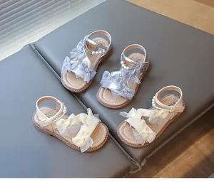 Detailed view of girls' princess sandals featuring elegant mesh bows and pearl decorations