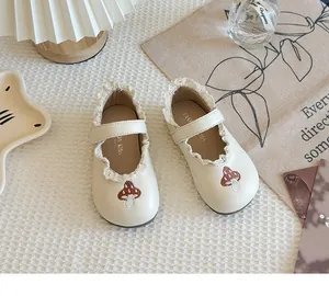 Cute beige girls leather shoes featuring lace trim and embroidered mushroom detail