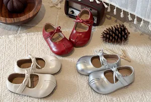 Detailed view of girls' Mary Jane princess shoes in red, white, and silver colors