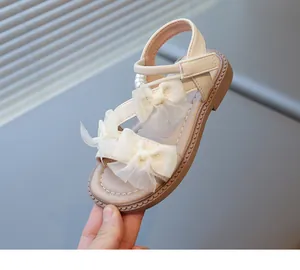 Elegant beige girls' princess sandals featuring double tulle bows and pearl details