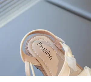 Detail shot of girls' beige princess sandal featuring a decorative bow and soft insole
