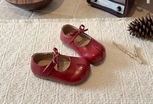 Elegant red Mary Jane leather shoes for girls with a decorative bow and split toe design