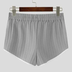Macro view of grey ribbed texture on men's casual shorts with white contrast piping