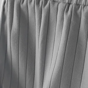 Close-up view of grey ribbed fabric and elastic waistband on men's sports shorts