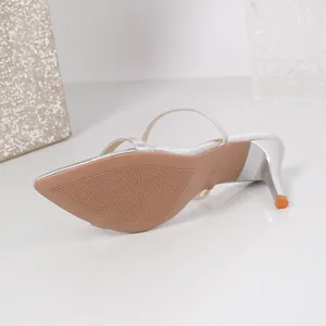 Detailed view of the tan sole and silver stiletto heel on a pointed-toe sandal