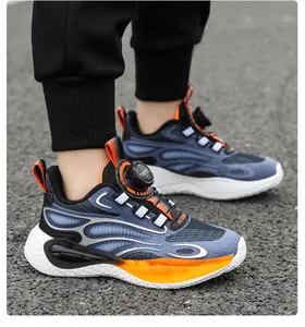 Close-up of boys' athletic shoes with rotary buckle in blue and orange colors