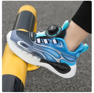 Close-up detail of boys' blue athletic sneakers with a rotating dial closure.