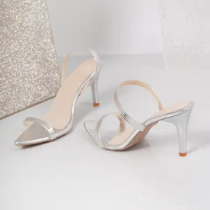Elegant silver pointed-toe high-heeled sandals with thin straps for women.