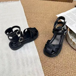 Detailed macro view showing the soft texture and buckles of black closed-toe girl's sandals