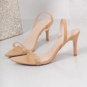 Elegant beige pointed-toe stiletto sandals with thin straps and glossy finish.