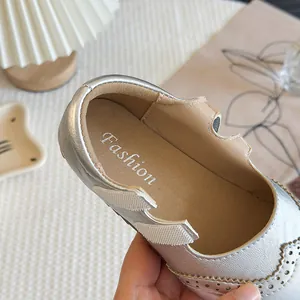 Elegant silver girl's brogue Mary Janes with decorative perforations and soft sole.
