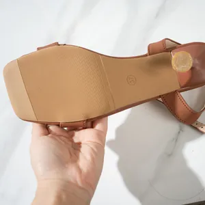 Detailed close-up view of a brown soft leather high-heeled sandal sole with size 37 mark.