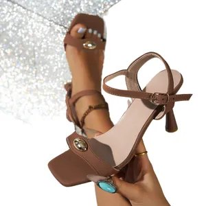 Elegant brown soft leather high heel sandals with gold metal buckle detail and ankle strap