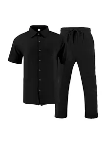 Detail view of men's black short-sleeved linen shirt and matching drawstring pants set