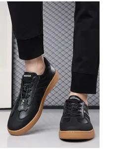 Close-up of retro black leather GAT style sneakers with gum rubber soles for men.