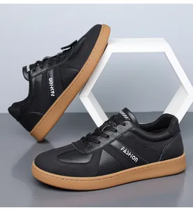 Close-up detail of black German Army Trainers with gum sole and pebbled leather texture.