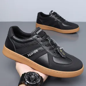 Premium black leather GAT sneakers with brown gum sole and fashion lettering detail