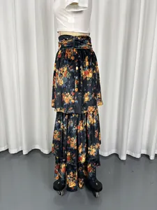 Detailed view of a vintage high-waisted floral tiered maxi skirt on a display mannequin.