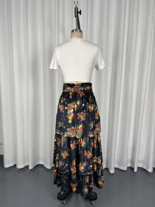 Detail of a vintage-style tiered floral maxi skirt with high waist design on a mannequin.