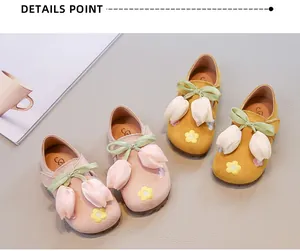 Detailed view of pink and yellow floral princess shoes for girls with tulip bows