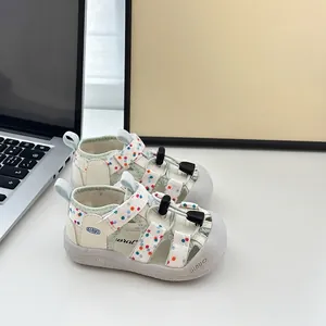 Primer plano de sandalias para niños con lunares de colores y suela blanda