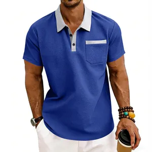 Detailed view of men's blue waffle knit polo shirt with contrast grey collar and pocket.