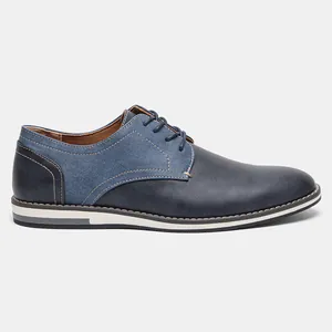 Side view of navy blue men's casual derby shoes with denim fabric patches and white sole