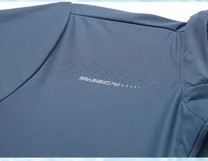 Close-up of laser-cut ventilation holes on blue men's sun protection jacket fabric