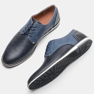 Close-up of men's navy leather casual shoes with denim texture panels and lace-up design.