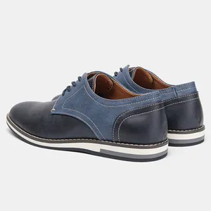 Close-up of blue patchwork men's casual shoes with denim-like fabric detail