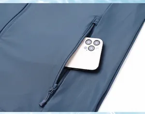 Close-up of side zipper pocket on blue sun protection jacket showing storage capacity