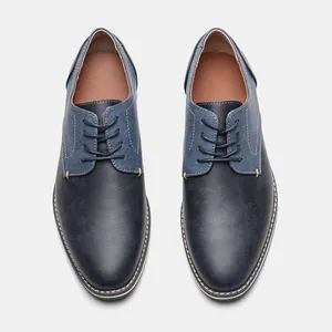 Detailed top-down view of men's navy blue casual shoes featuring canvas patchwork design
