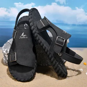 Detail view of black men's leather beach sandals with adjustable metal buckles.